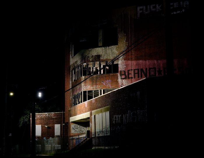 The abandoned hospital where vampires reside, seen at night